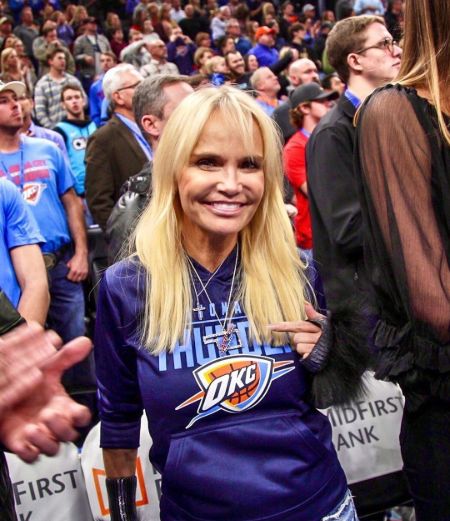 Kristin Chenoweth in a Oklahoma shirt poses for a picture.